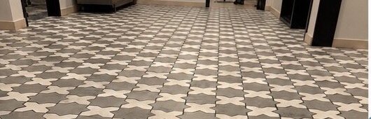 Before: star pattern commercial tile and grout before and after cleaning